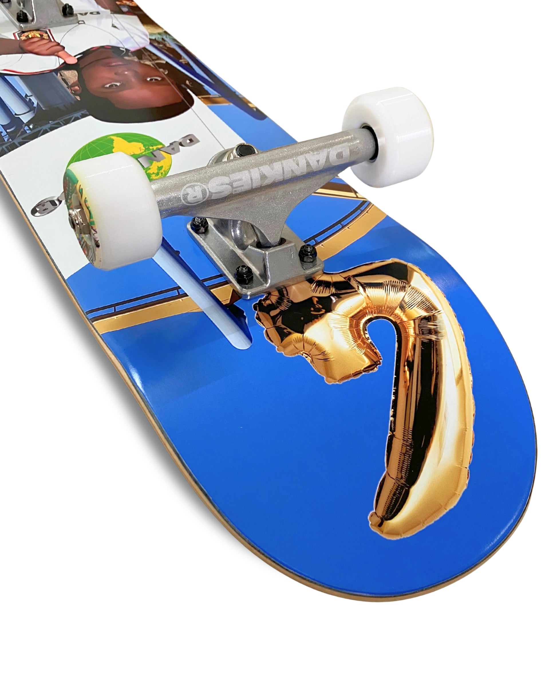 Dankies 4L Complete Skateboard with 4th Anniversary Graphic that features a kid holding a Number 4 balloon in a theme park - tilted angle from top