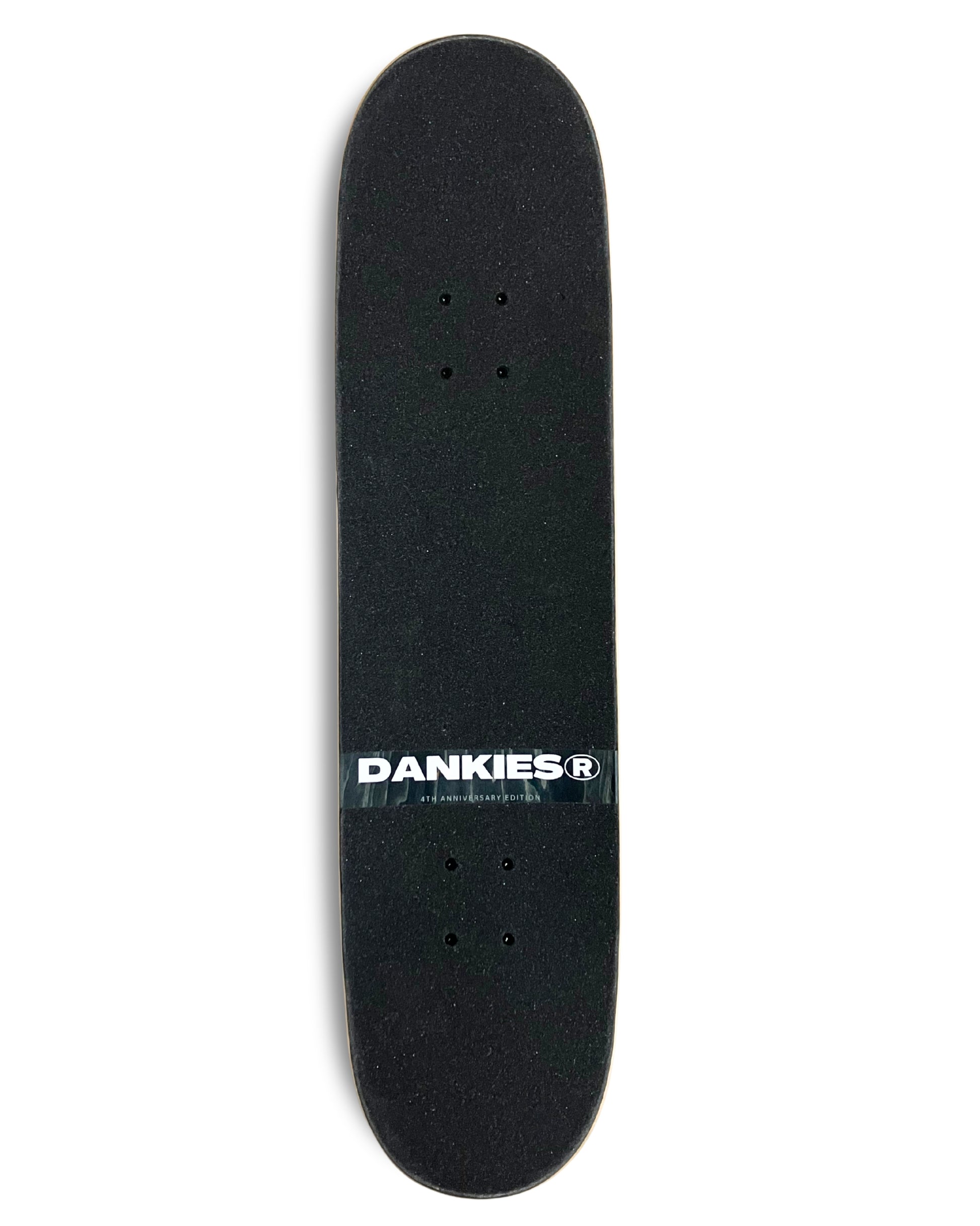 Dankies 4L Complete Skateboard with 4th Anniversary Graphic that features a kid holding a Number 4 balloon in a theme park - grip tape area