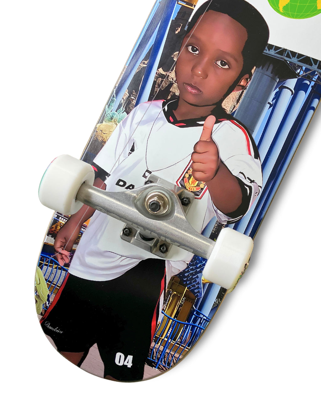 Dankies 4L Complete Skateboard with 4th Anniversary Graphic that features a kid holding a Number 4 balloon in a theme park - bottom