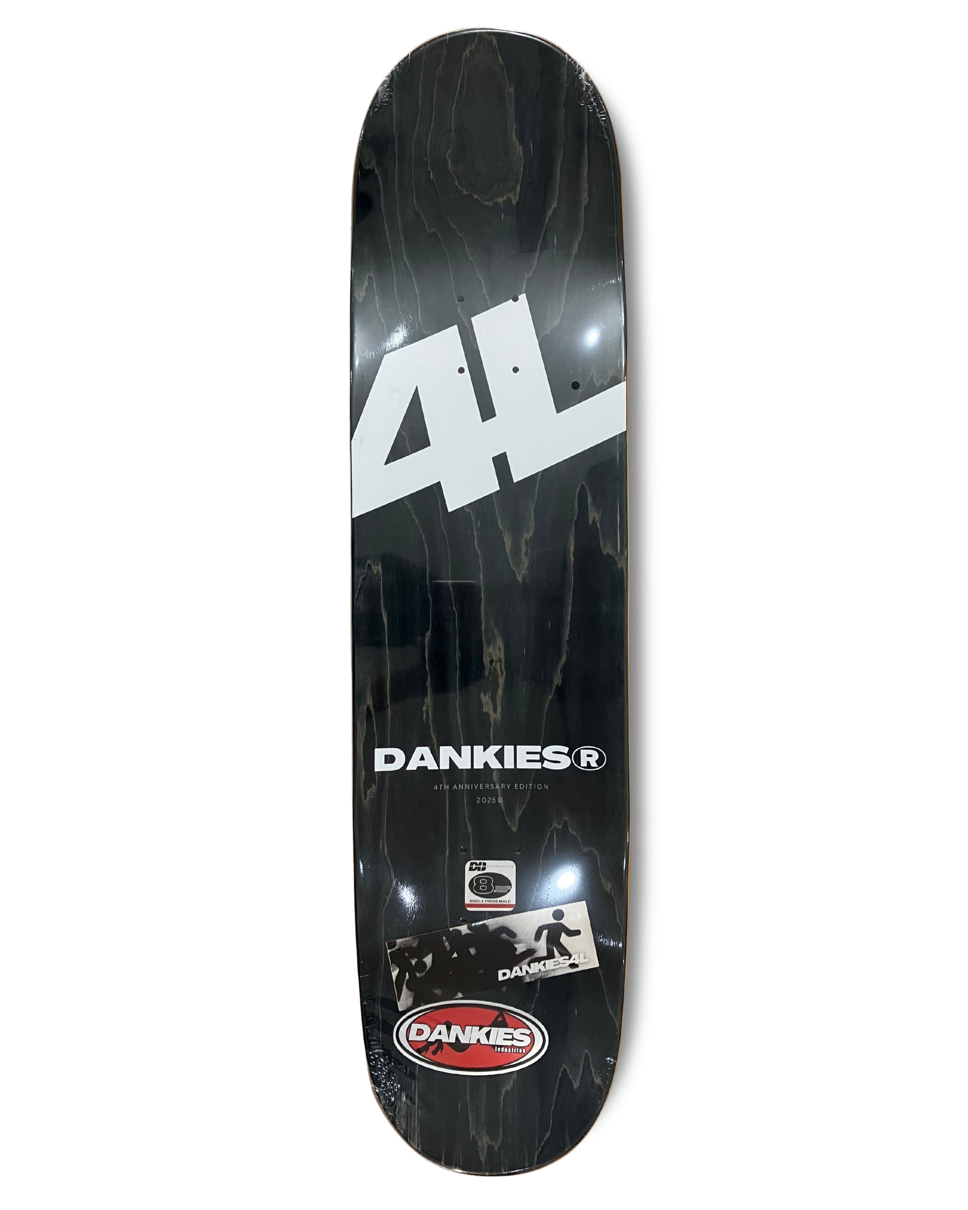 Dankies 4L Skateboard deck with 4th Anniversary Graphic that features a kid holding a Number 4 balloon in a theme park - grip tape area